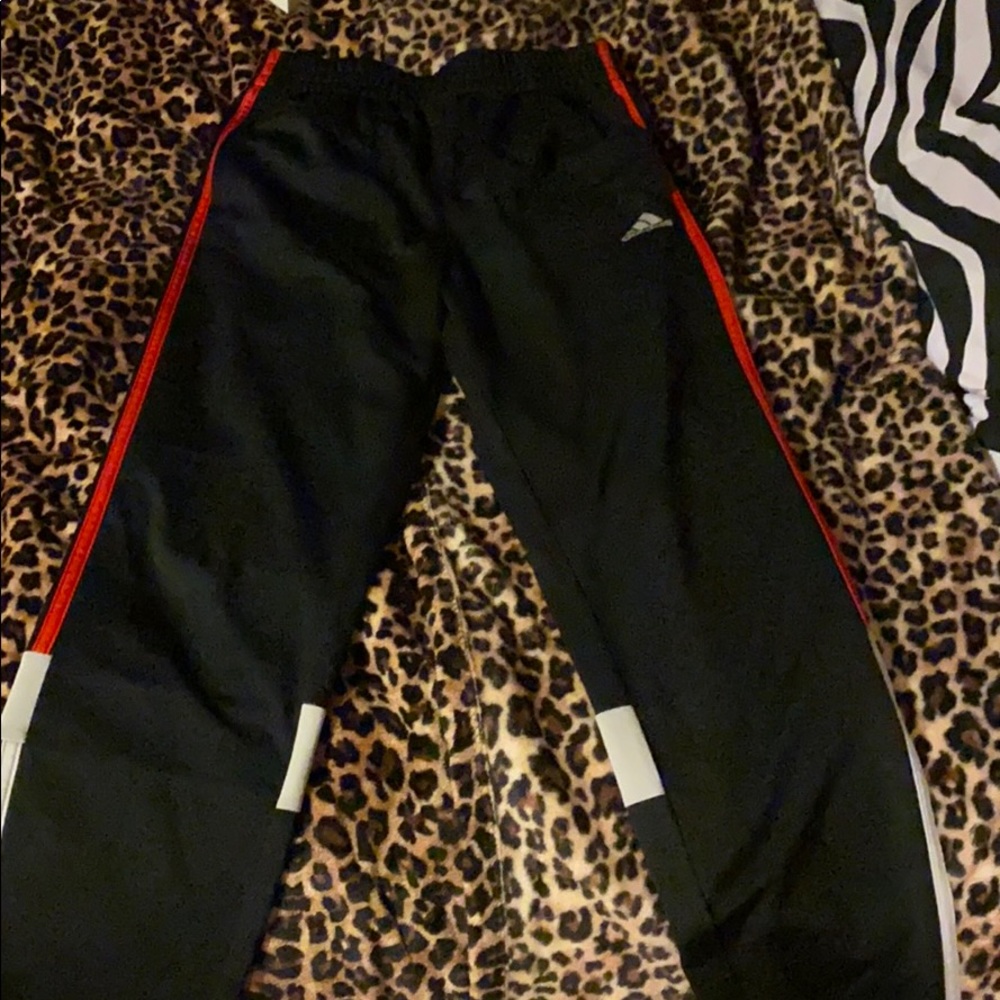 Black, red, and white Adidas pants